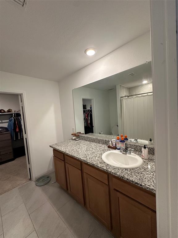 2928 Dora Drive Fort Worth, TX 76119 - Photo 7 of 15 a bathroom with a granite countertop sink and a mirror