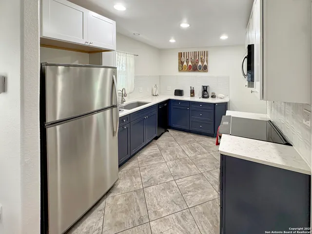a kitchen with stainless steel appliances a refrigerator and a sink