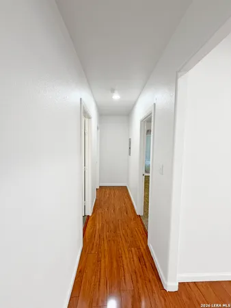 a view of hallway with wooden floor