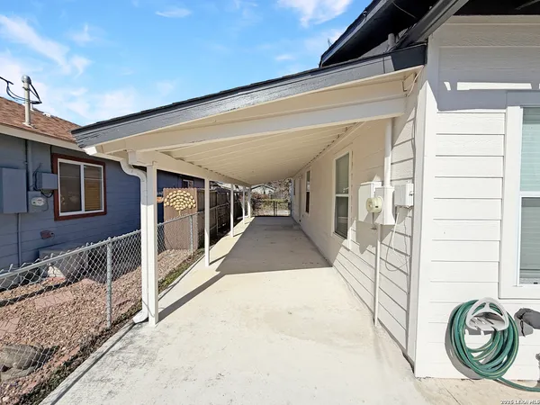 a view of a porch with furniture and a gate