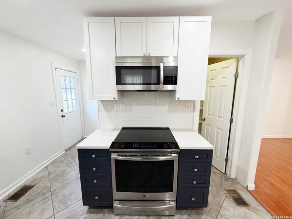 a kitchen with a stove and a microwave
