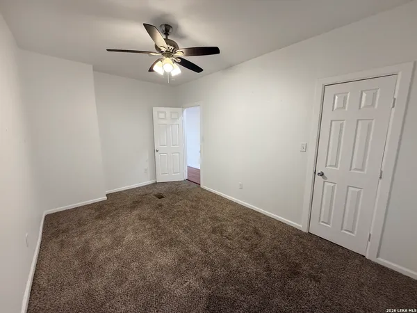 a view of a livingroom with a ceiling fan and wooden floor