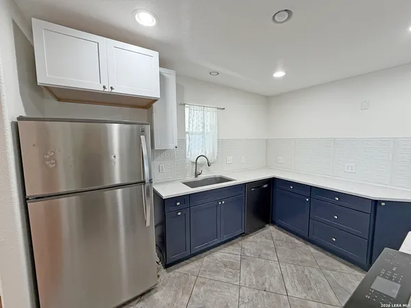 a kitchen with a sink stainless steel appliances and cabinets