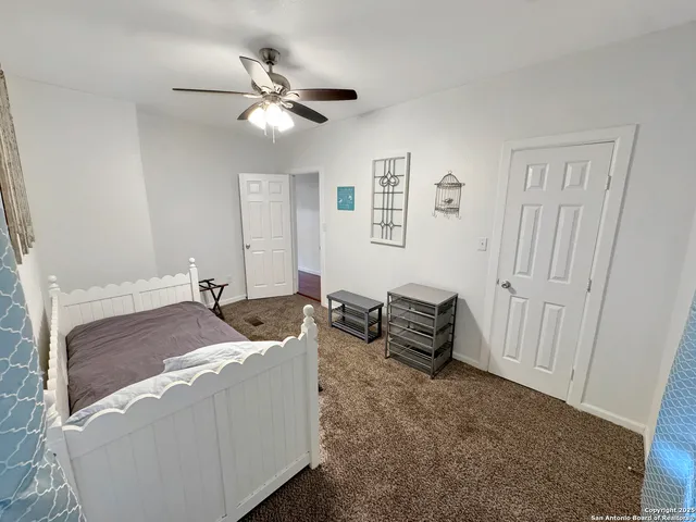 a living room with furniture and a ceiling fan