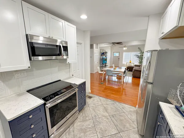 a kitchen with a stove a microwave and refrigerator