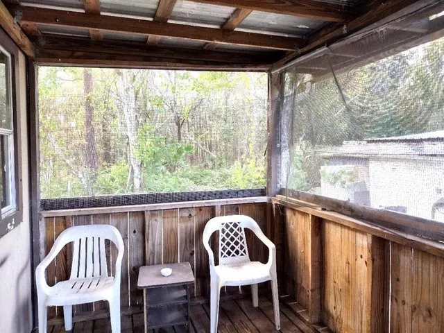 a view of a chairs and table in patio with wooden fence