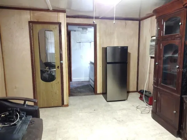 a kitchen with a refrigerator and cabinets