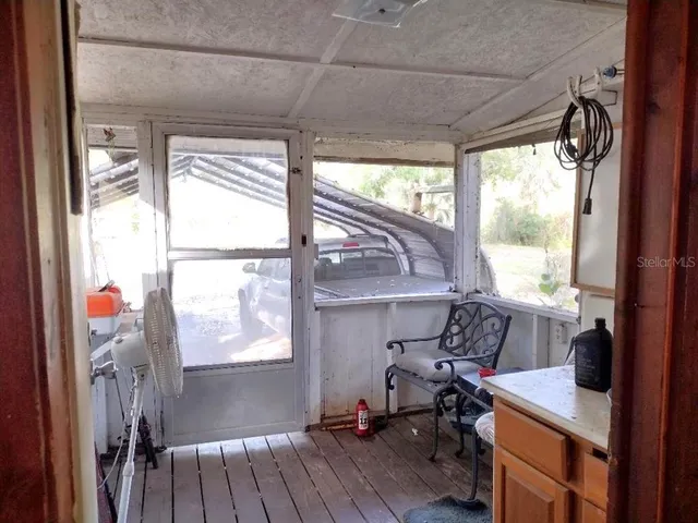 a view of workspace with wooden floor and windows