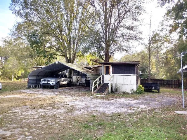 a house that has a tree in front of it
