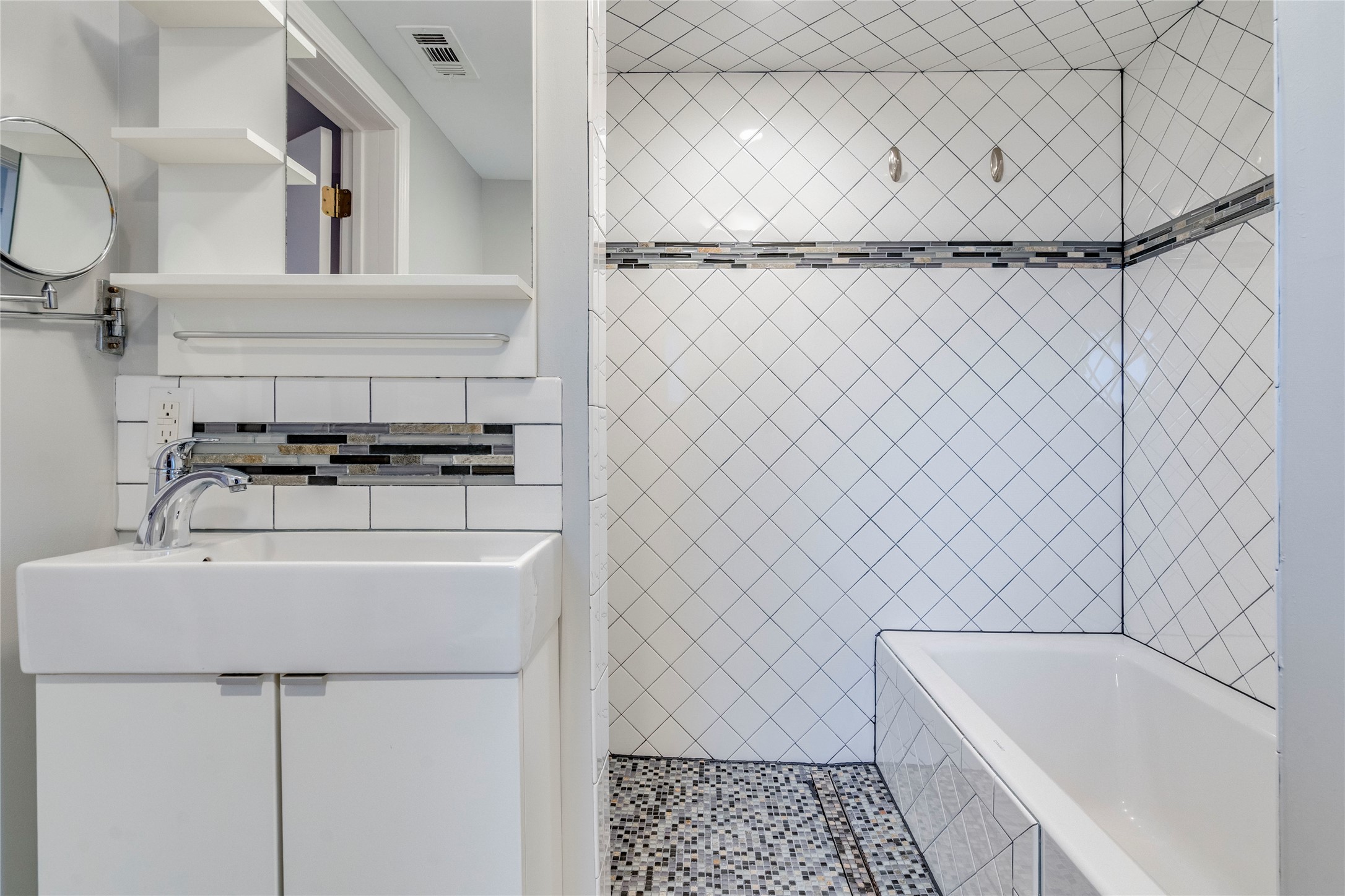 2314 Santa Rosa Street Austin, TX 78702 - Photo 15 of 29 A clean, compact bath features a modern sink vanity and tiled tub-shower combination.