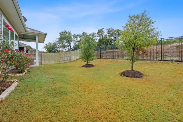 a swimming pool with trees in front of it