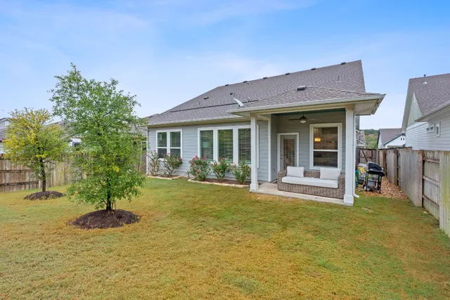 a view of a house with backyard porch and sitting area