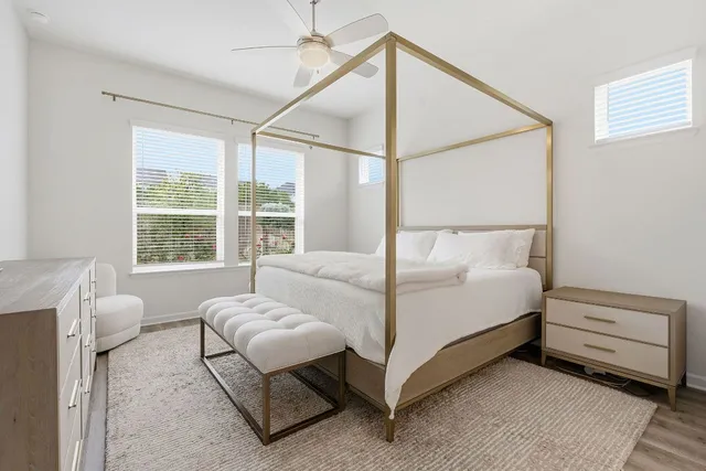 a bedroom with a bed and a window