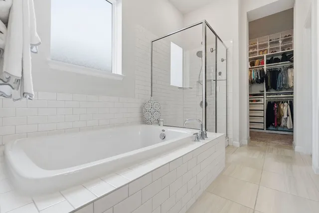 a spacious bathroom with a bathtub and a shower