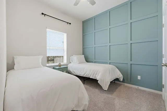 a bedroom with two beds and a closet