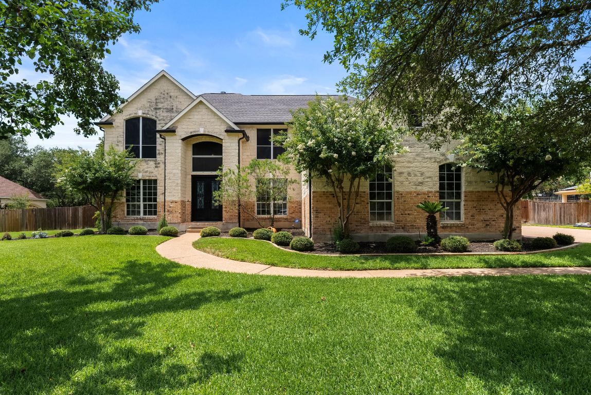 a front view of a house with a yard and garage