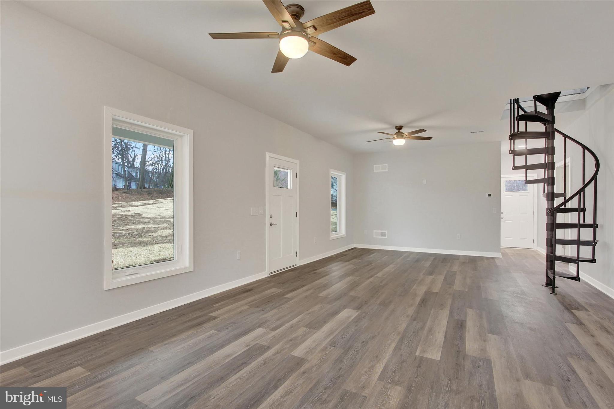 2 Pecan Trail Fairfield, PA 17320 - Photo 12 of 45 an empty room with wooden floor chandelier fan and windows