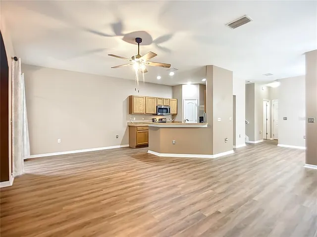 a view of a kitchen with a dishwasher cabinets and wooden floor