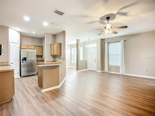 a view of a kitchen with wooden floor and a kitchen