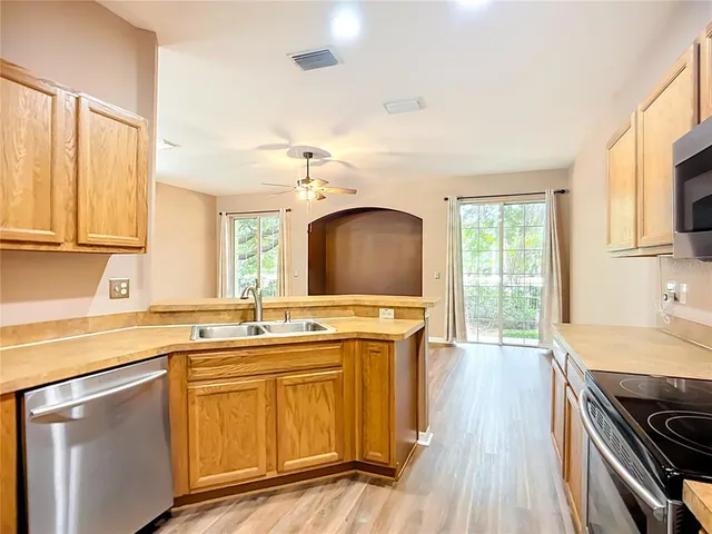 a kitchen with stainless steel appliances granite countertop a stove and a sink