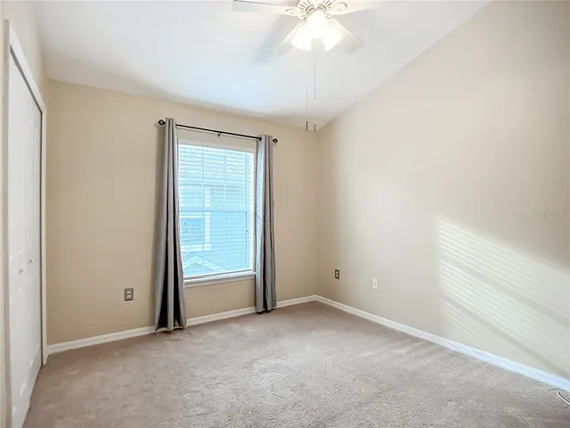 an empty room with a ceiling fan