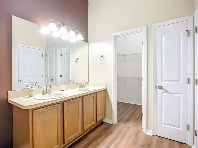 a bathroom with a double vanity sink and mirror