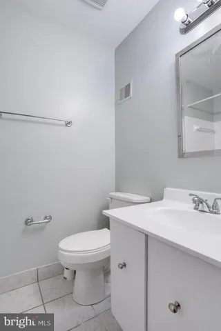 a bathroom with a sink a toilet and mirror