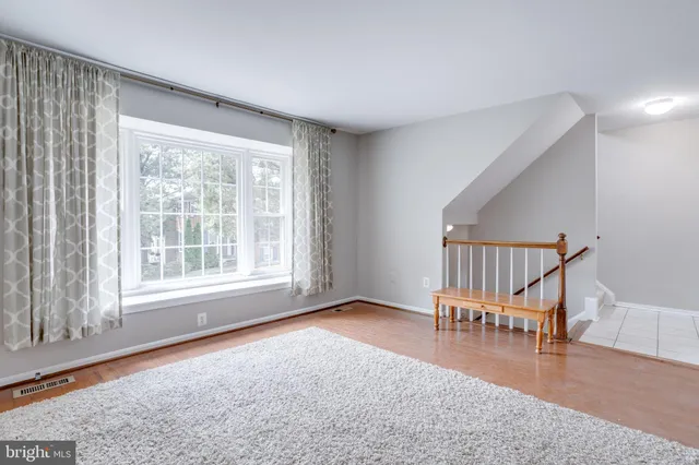 a view of livingroom with furniture wooden floor and windows