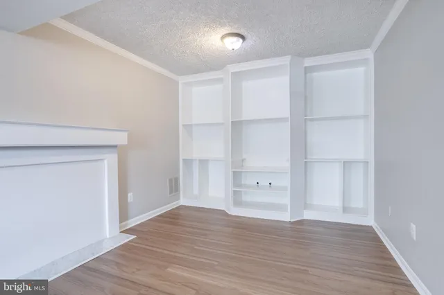 a view of walk in closet with wooden floor