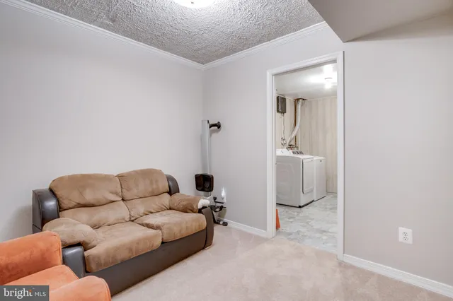 a living room with furniture and a walk in closet