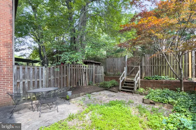a view of a chair and table in backyard