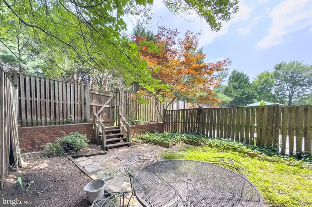 a view of a backyard with a small pool and plants