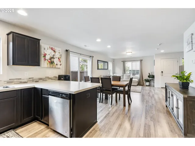 a open kitchen with stainless steel appliances granite countertop a stove and a wooden cabinets