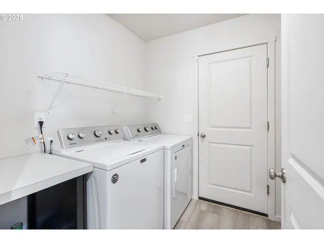 a utility room with cabinets washer and dryer