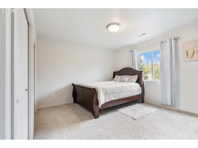 a bedroom with a bed and window