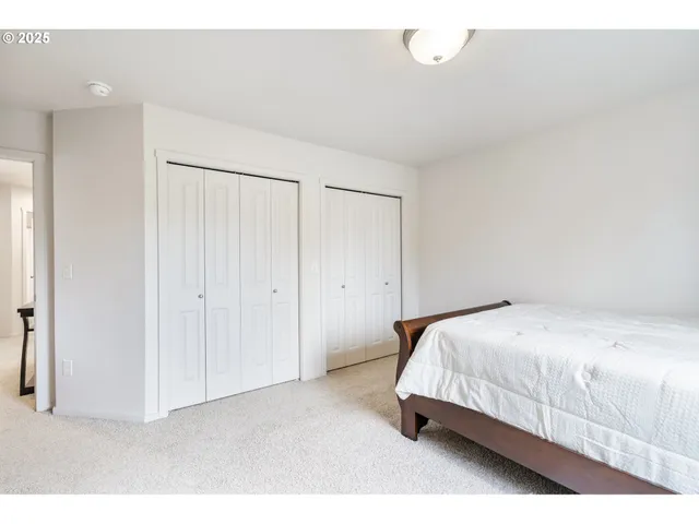 a bedroom with a bed and a painting