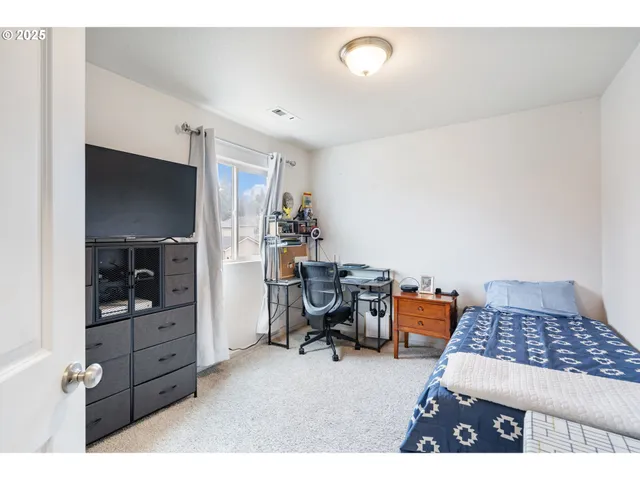 a bedroom with furniture and window