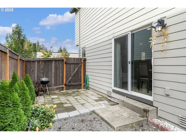 a backyard of a house with yard and outdoor seating