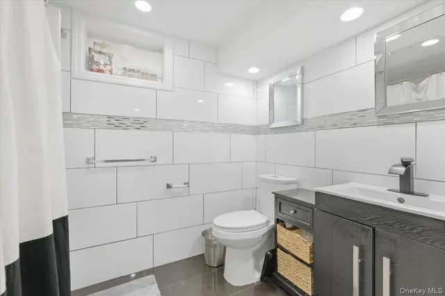 a bathroom with a toilet sink and vanity