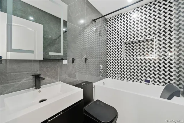 a bathroom with a sink toilet a mirror and shower