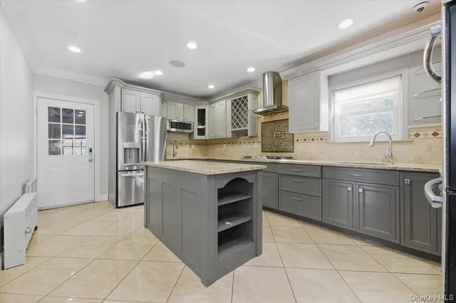 a kitchen with stainless steel appliances granite countertop a refrigerator and sink