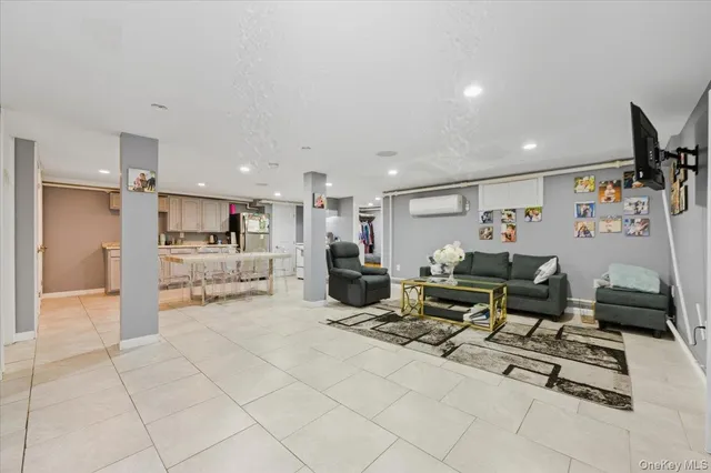 a living room with furniture a kitchen view and a sink