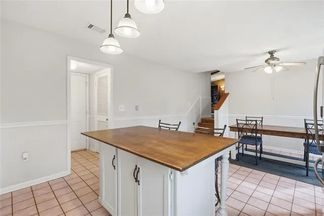 a kitchen with stainless steel appliances a refrigerator a stove a sink and white cabinets