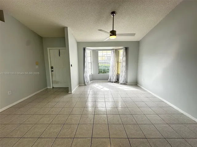 a view of an empty room with glass door