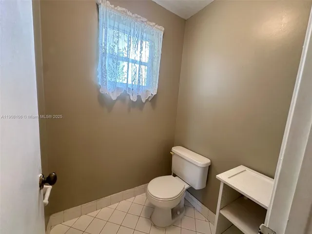 a white toilet sitting next to a window