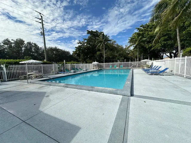 a view of a swimming pool with a lawn chairs