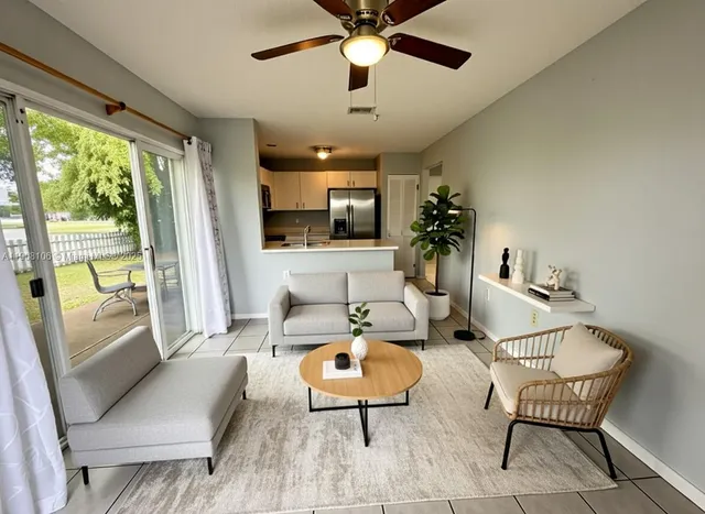a living room with furniture and a large window