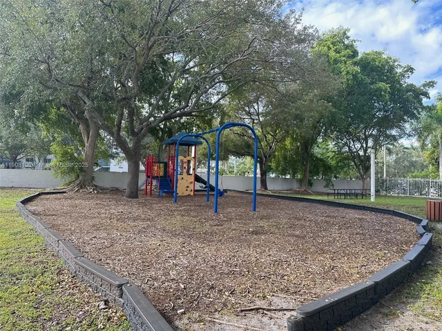 a view of a backyard with large trees