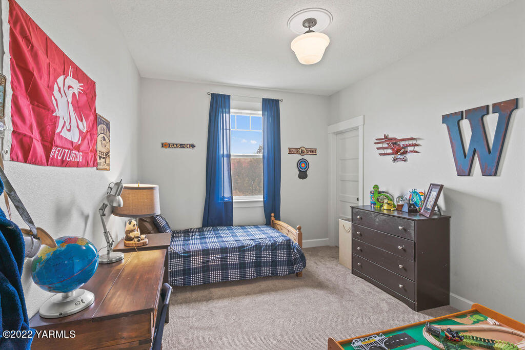 1058 East Road Bickleton, WA 99322 - Photo 17 of 39 a bedroom with a bed and wooden floor