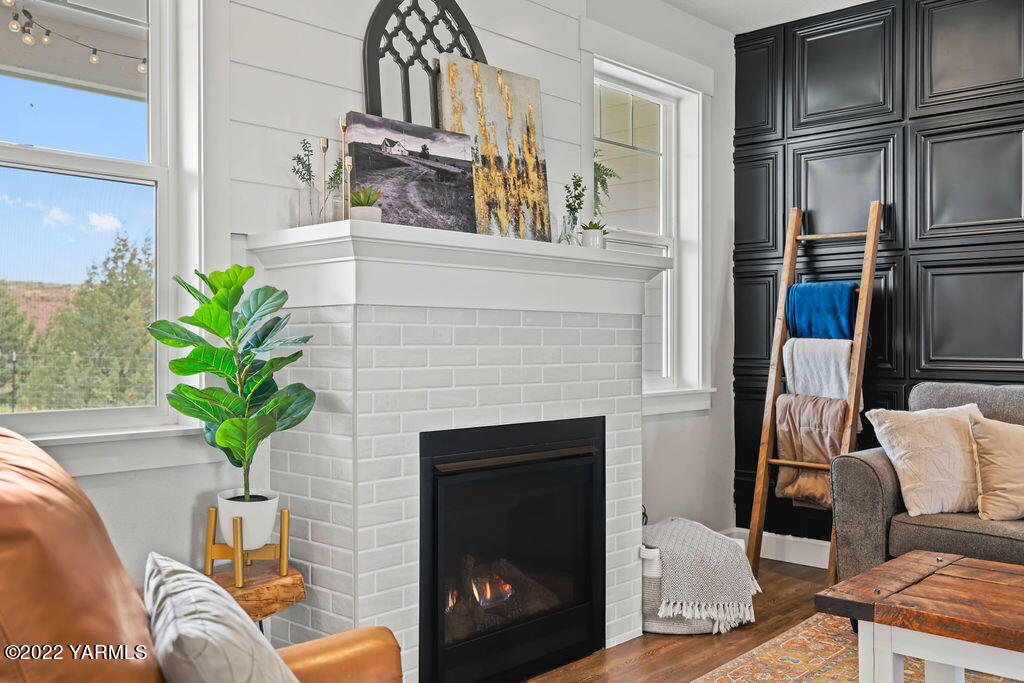 1058 East Road Bickleton, WA 99322 - Photo 20 of 39 a living room with furniture a fireplace and a potted plant